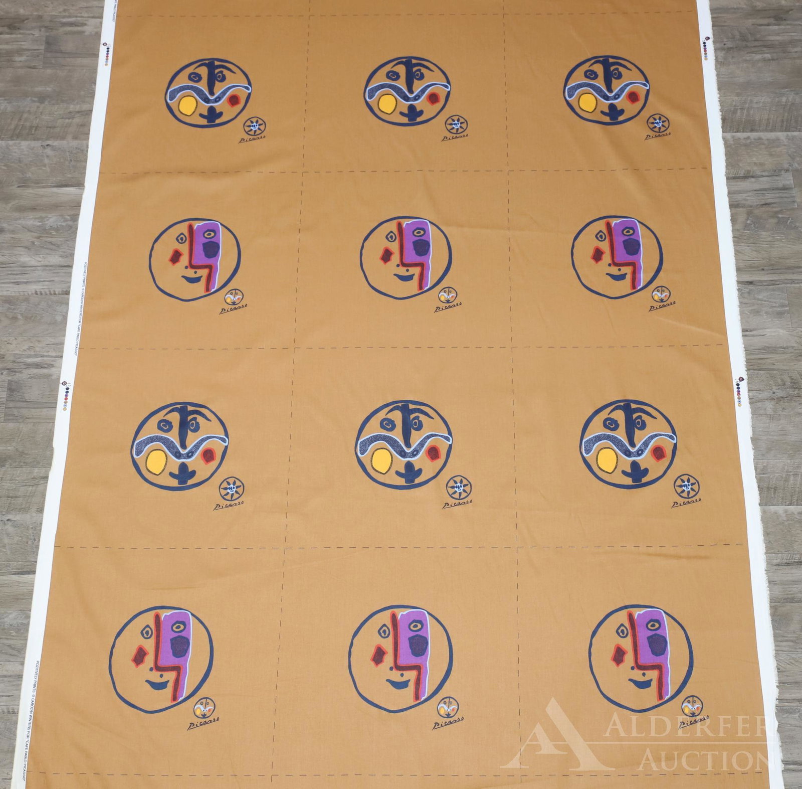 "Cafe Pablo Picasso" Bolts of Fabric: 3 bolts of cotton fabric with dotted cut lines and marked selvage, made by Pozitively Prints. Brown/gold background with figural medallions. Approximately 15 yards per bolt.