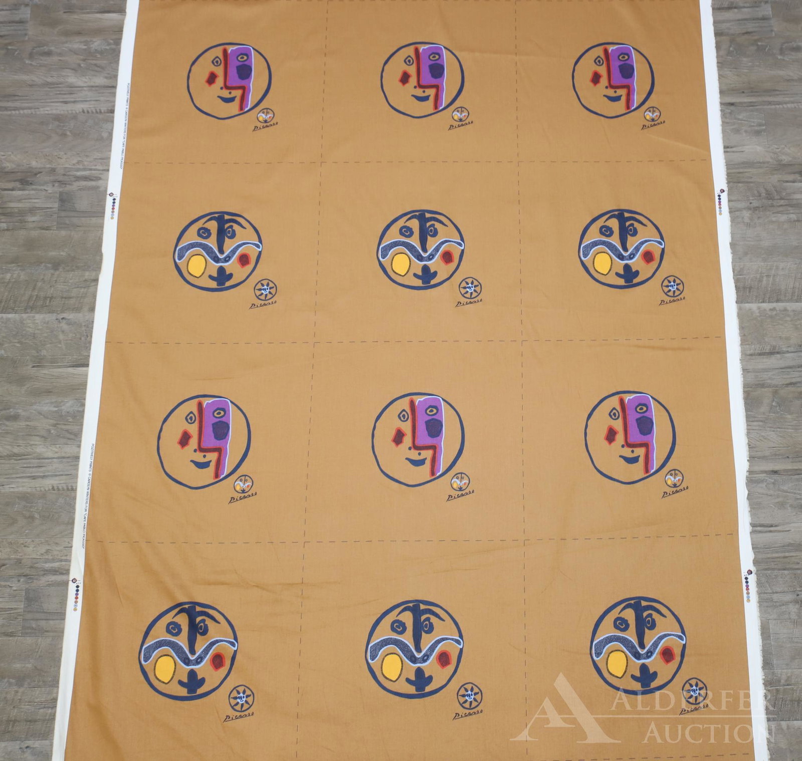 "Cafe Pablo Picasso" Bolts of Fabric: 3 bolts of cotton fabric with dotted cut lines and marked selvage, made by Pozitively Prints. Brown/gold background with figural medallions. Approximately 15 yards per bolt.