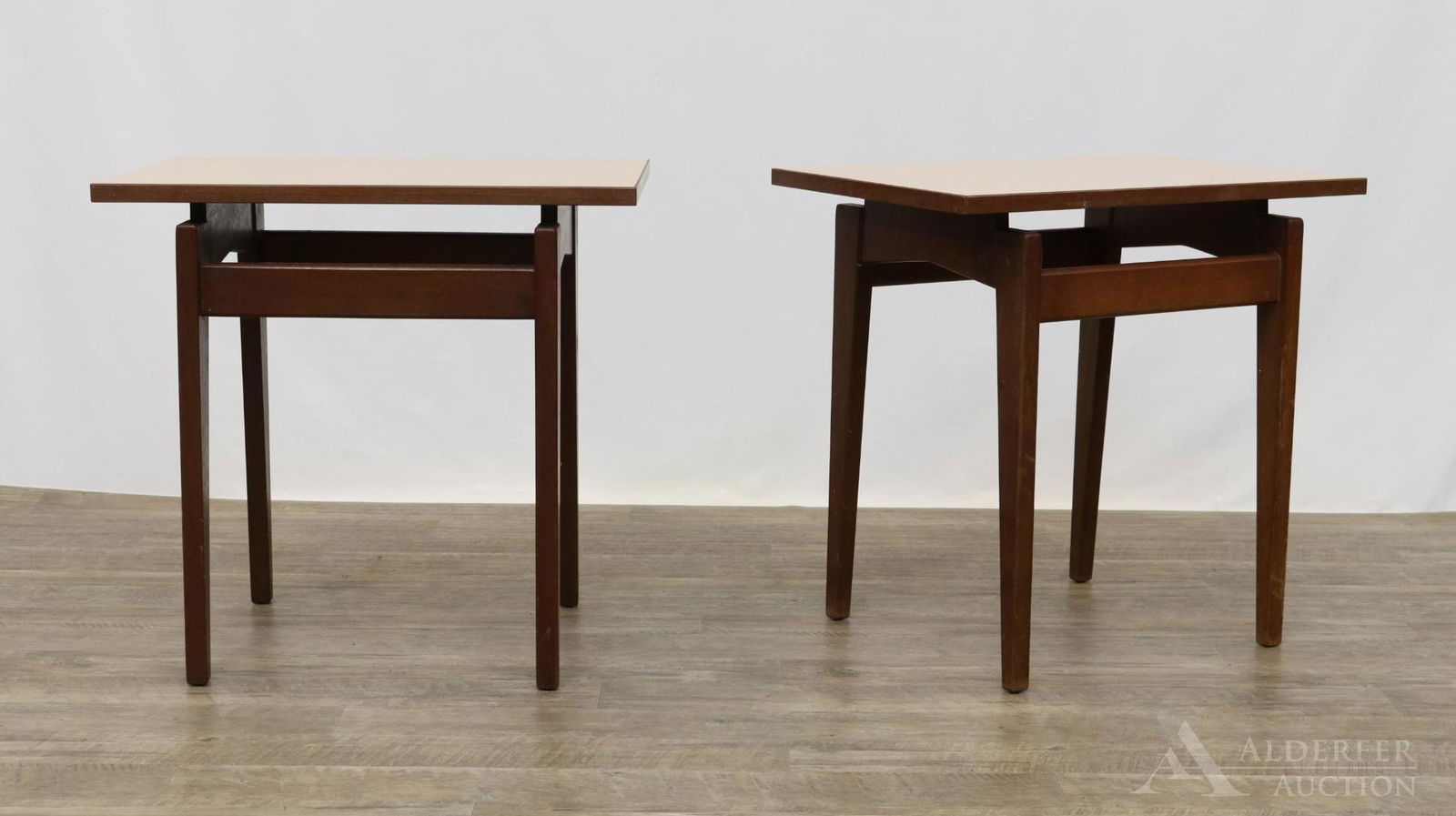 Pair of Jens Risom Side Tables: (2) Walnut tables with floating laminate top and rectangular tapered legs, marked underside. 23”h x 24”w x 16”d