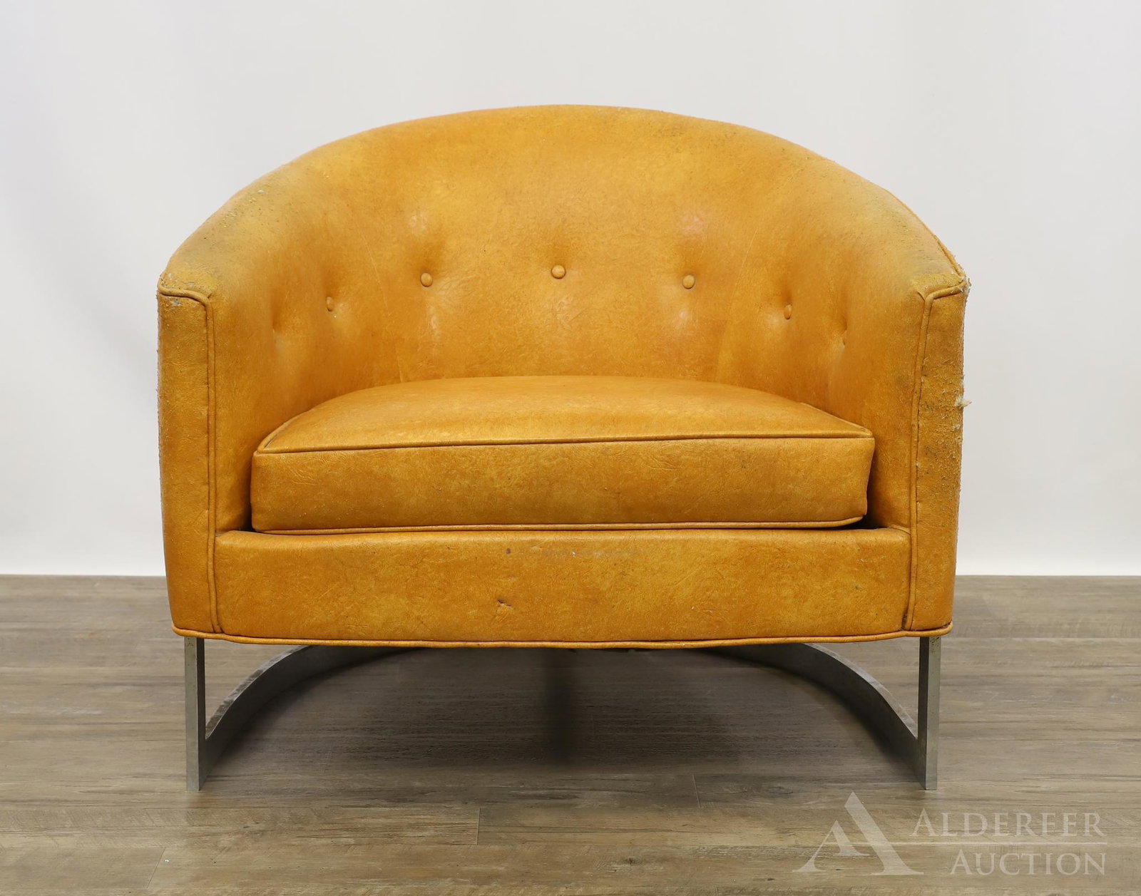 Attributed to Milo Baughman Club Chair: Barrel back chair with light brown leather upholstery on a steel frame. 25"h x 30"w x 25"d