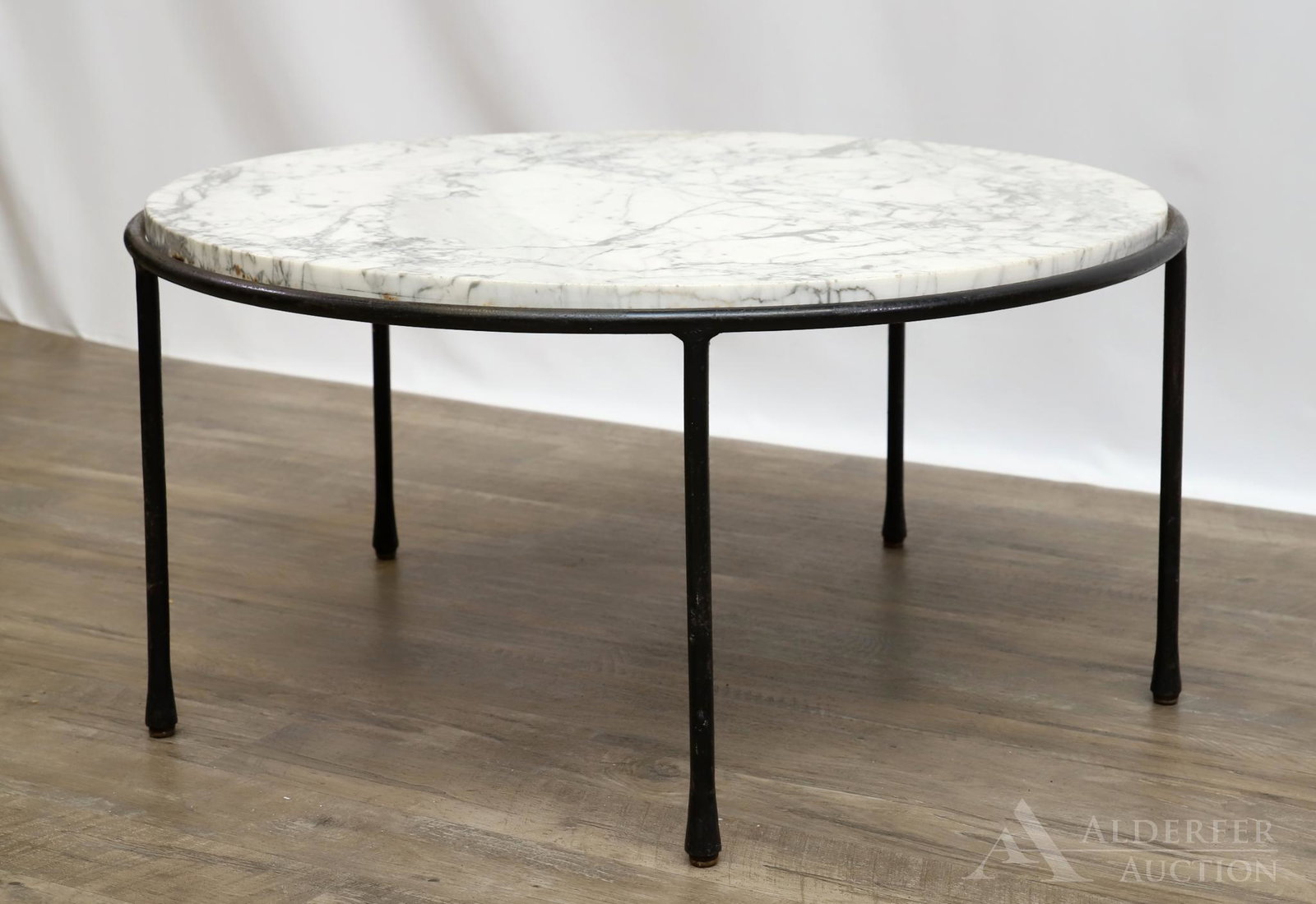 In the Manner of Paul McCobb Coffee Table: Painted wrought iron frame with round marble top. 15"h x 31" round