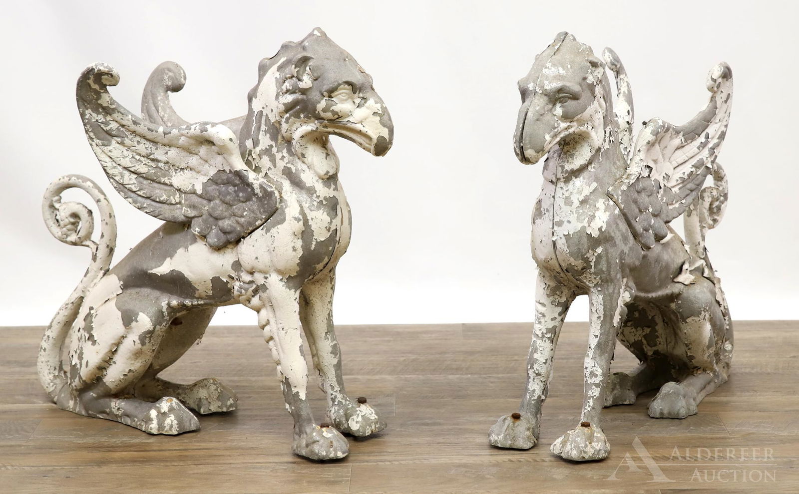 Pair of Aluminium Griffins: (2) Painted griffin statues, much paint loss throughout. 22"h x 24"w