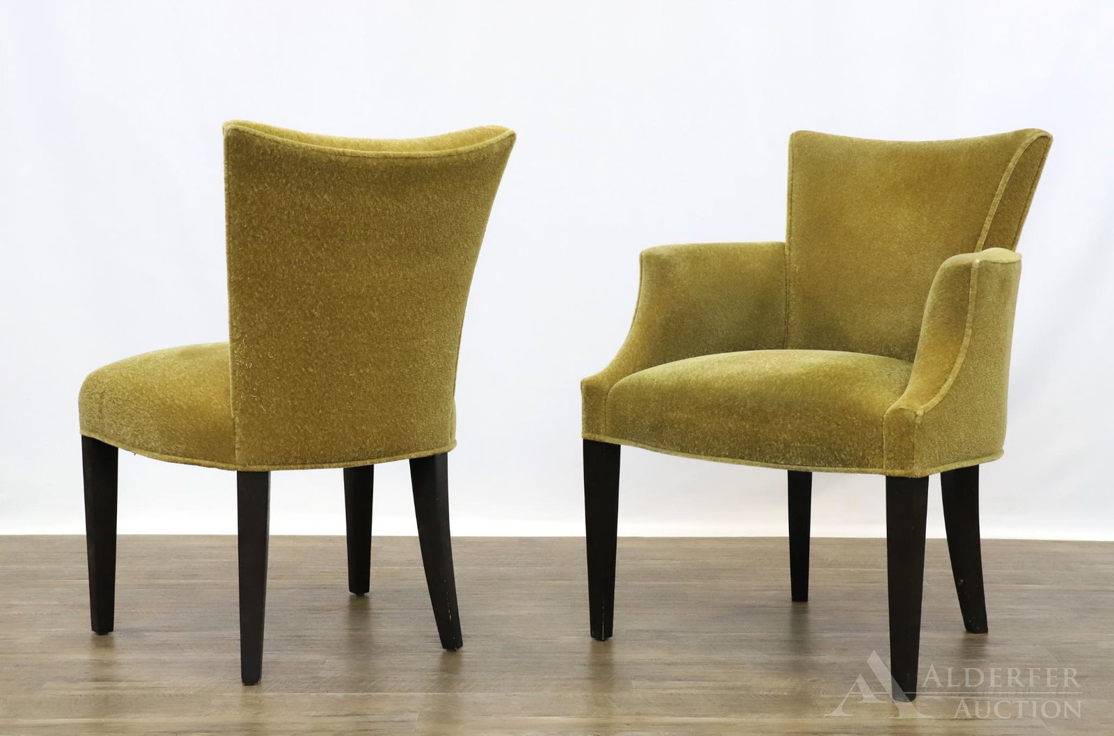 Pair of Donghia Upholstered Arm Chairs: High back with sculptured arms and upholstered with plush green fabric. Exposed tapered legs. Marked on bottom. 34"h x 25"w x 19"d