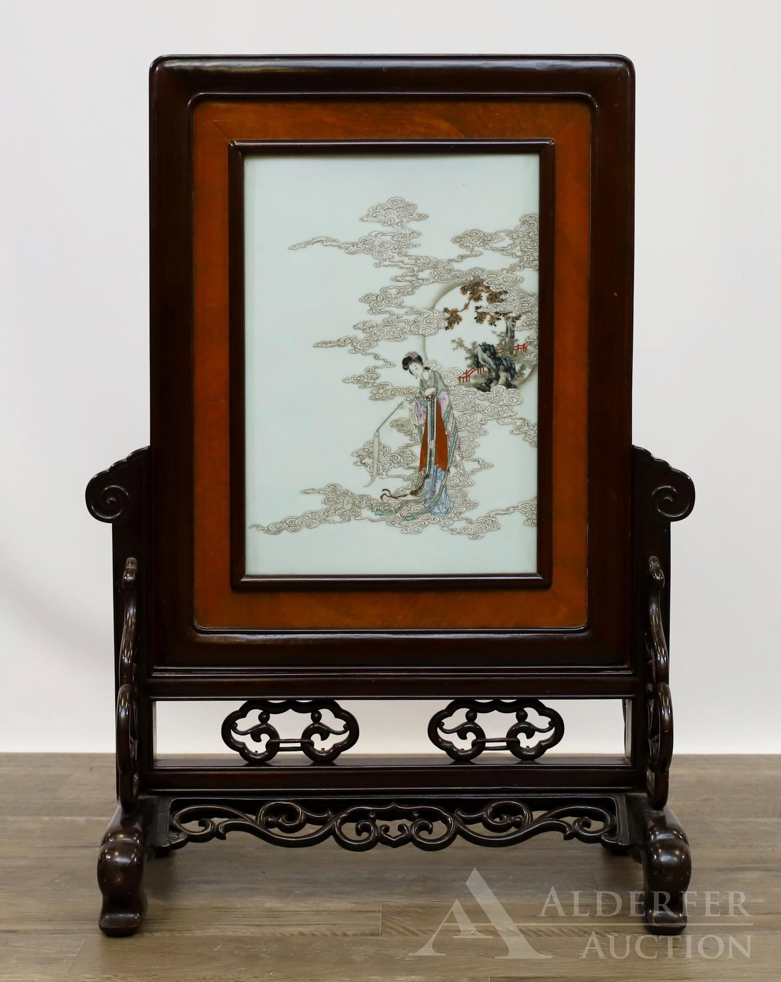 Chinese Porcelain Plaque Table Screen: Chinese figural female porcelain plaque with a rosewood open fretwork base and scrolled legs. Damage to fretwork on back of screen. 33"h x 22"w x 13"d