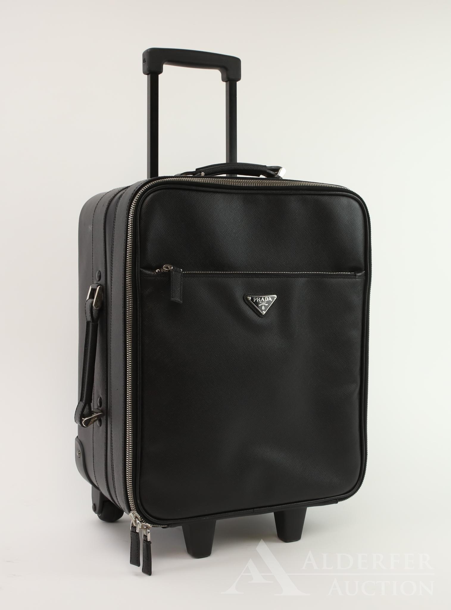 Prada Luggage: Prada nylon and leather carry on rolling luggage. 18"h x 14"w x 9"d