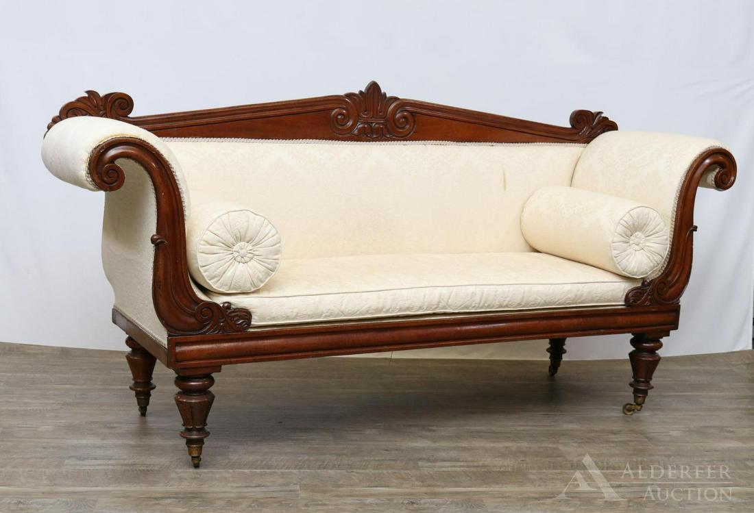 Carved Walnut Settee: Crown floral center crest motif, scrolled arms, on round tapered legs with casters. 39"h x 79"w x 23"d