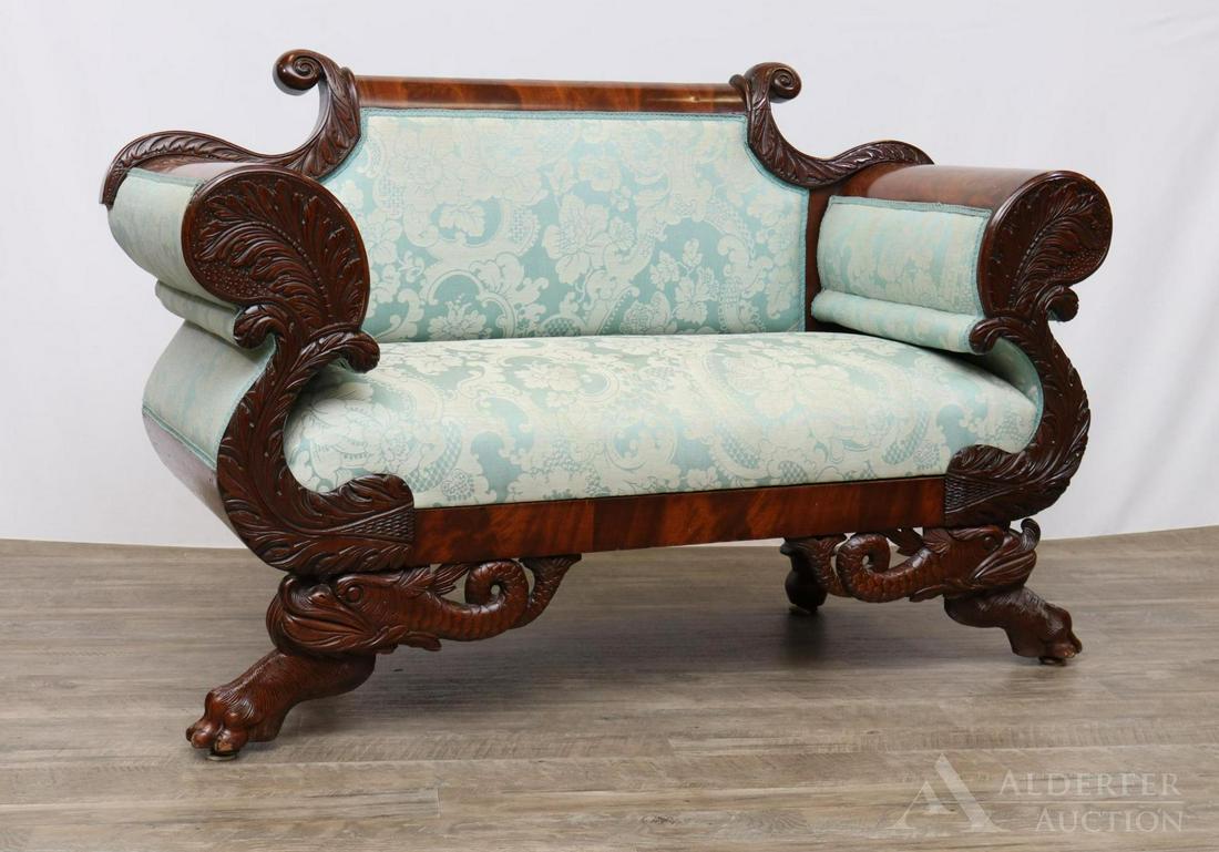 Federal Ornate Carved Mahogany Settee: Scroll back and arms with richly carved acanthus leaf and dolphin motifs resting on hairy paw feet. Blue damask upholstery. 34"h x 57"w x 20"d