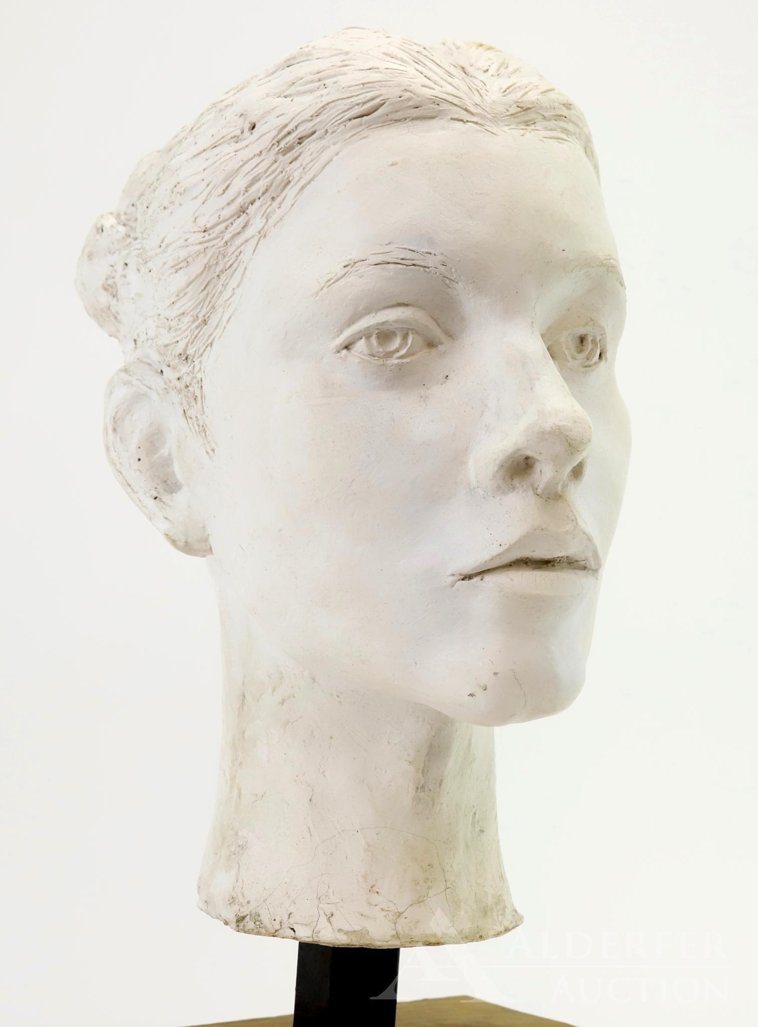 Ben Marcune (20th Century): Painted plaster sculpture of a female head. 18.5”h x 8”w