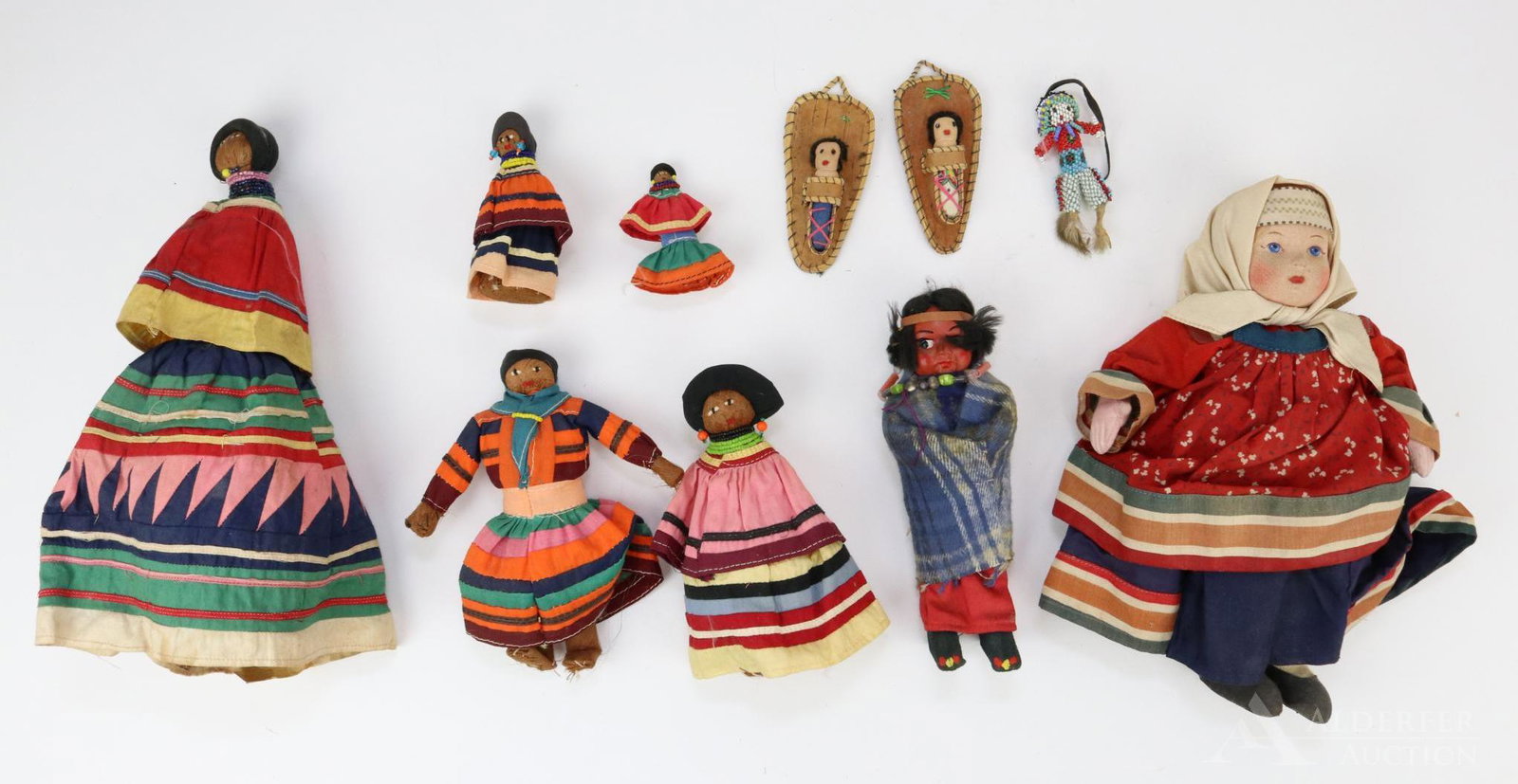 LOT OF MISC. NATIVE AMERICAN/OTHER DOLLS.: Native American - (5) Seminole palm dolls from Florida 2" - 10 1/2". 7" Skookum type child doll. (2) 4" Papooses. 3" All beaded doll. ALSO, 10" cloth peasant doll marked Soviet Union. Condition: some 