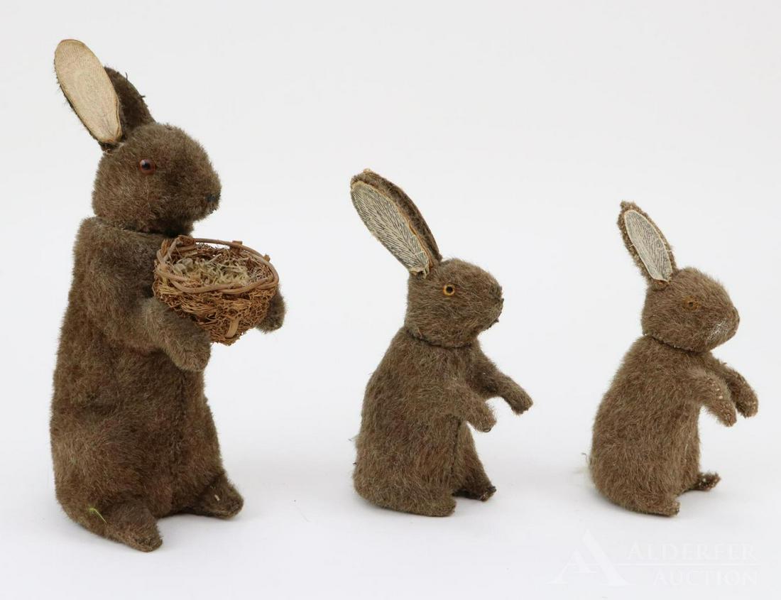 LOT OF HOLIDAY/NOVELTY.: Lot of (3) unmarked Rabbit candy containers. Papier mache with brown mohair covering. All have glass eyes, paper ear lining, white fur tails. 5 1/4", 6", 8" (holding a basket). Condition: some age los