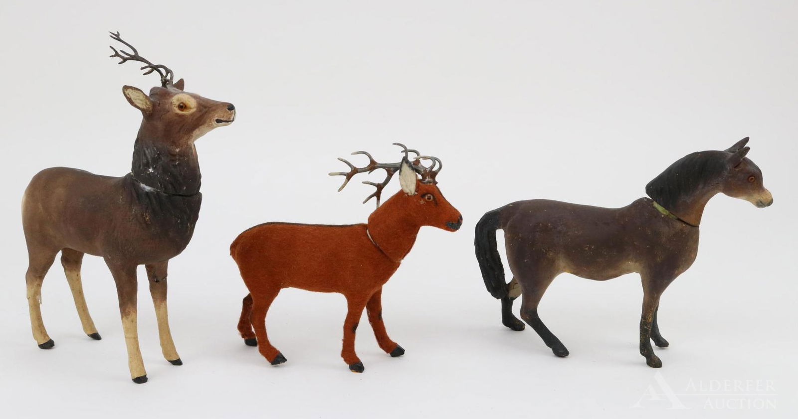 LOT OF HOLIDAY/NOVELTY.: Lot of (3) papier mache candy containers. Pair of German Deer. Both have glass eyes, metal antlers and have a round paper label on stomach. Papier mache - 6 1/2" Is brown. Condition: left leg and left