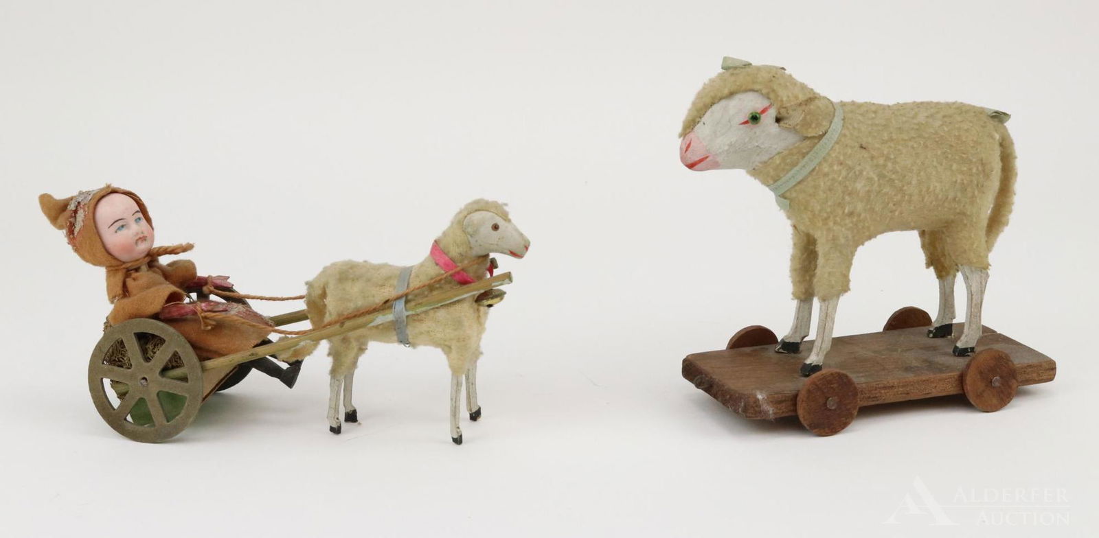 LOT OF HOLIDAY/NOVELTY.: Pair of German sheep toys. 6" T. papier mache sheep with green glass eyes, wrapped in cloth. Sheep is standing on a wooden wheeled platform to be pulled. Squeaks when back is pushed down. 7" L toy wit