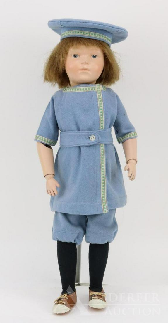 LOT OF SCHOENHUT(S).: 21" Model No. 308. Doll has the oval decal on back of torso. Replaced brown human hair wig. Blue integlio eyes. Dressed in vintage wool Russian style suit with matching sailor hat. Brown/ivory oilclot