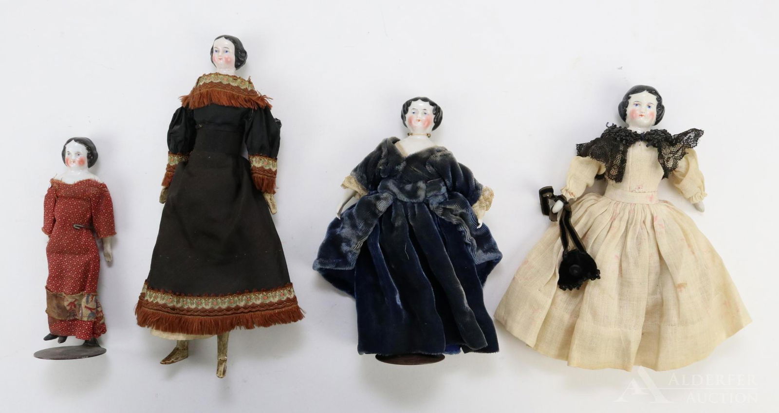 LOT OF CHINA/PARIAN DOLL(S).: Lot of (4) china shoulder head dolls with black center part hair, blue eyes, nice cheek coloring. All of them are dressed in either antique or vintage clothing. 5 1/2" Unmarked doll has parian lower l