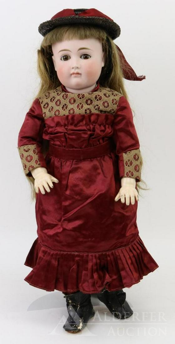 ANTIQUE GERMAN BISQUE HEAD DOLL.: 21" "7" Closed mouth "Pouty" doll. Brown sleep eyes, long brown human hair wig, plaster pate. Early papier mache jointed body with straight wrists. Dressed in beautiful antique burgundy silk dress wit