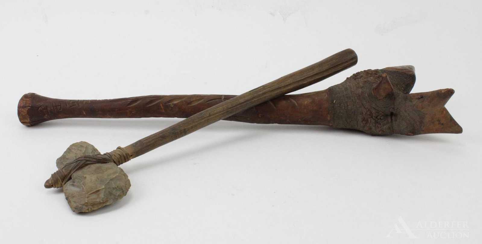 Pair of Native American War Clubs: (2) Hand carved war clubs. One with wooden handle and attached "worked stone" head. The second with a carved handle and marked "Indian Island" and multiple point head. 19.5" long and 14.5" long