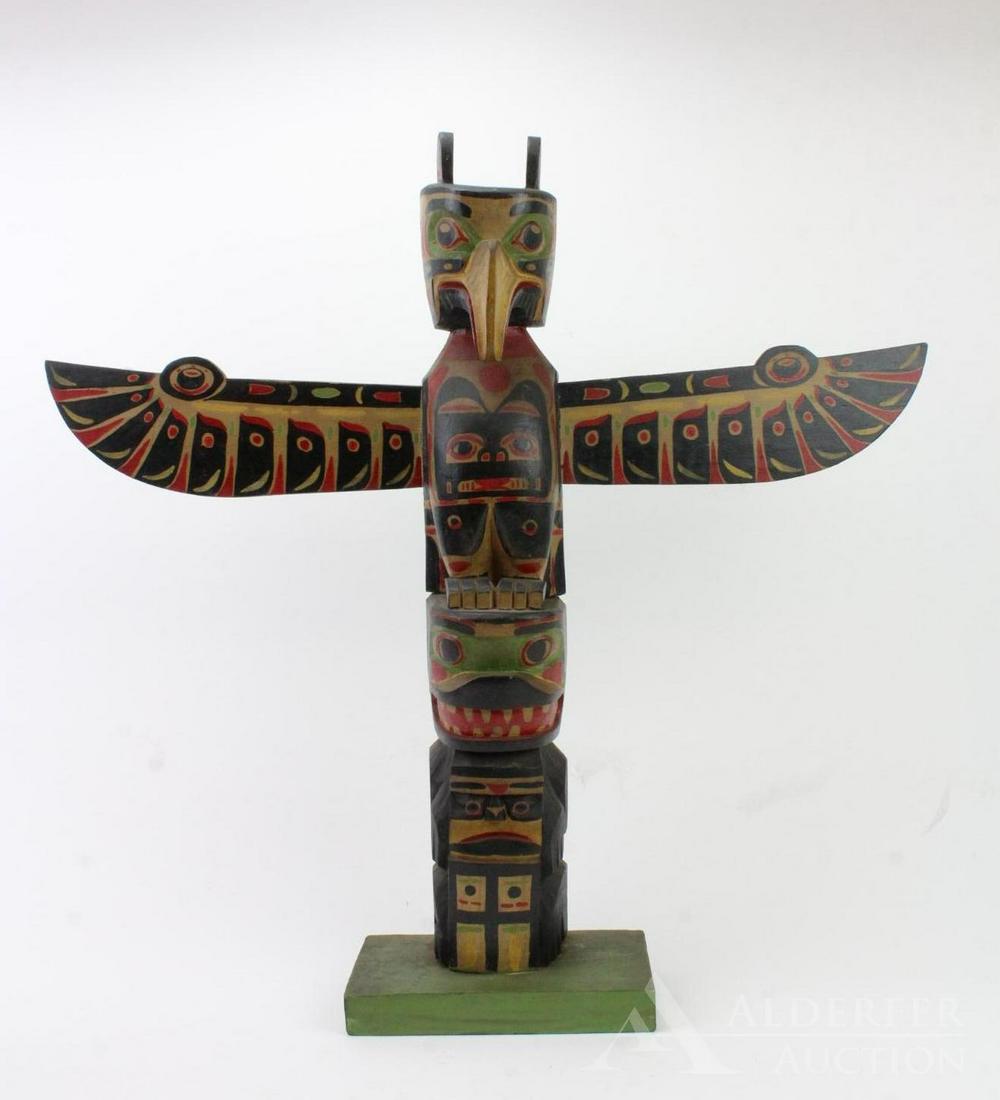 Hand Carved and Painted Totem Pole: Winged totem pole with eagle and figural carvings and brightly painted. 25.75"h x 27"w