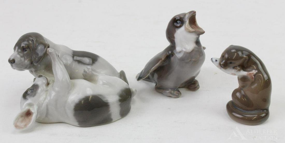 Danish Porcelain Grouping: Grouping includes Royal Copenhagen puppies playing (453), Bing and Grondahl baby bird (1852E), and Royal Copenhagen sea otter with fish (2333). Items measure 2.75" h; 2"h & 3.5" length.