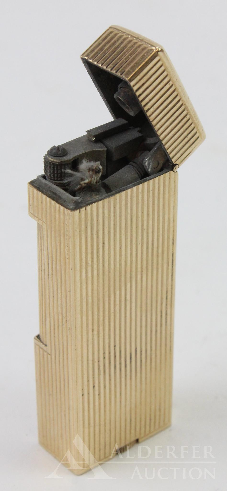 Dunhill 14k Lighter: Dunhill flip top lighter with 14k outer jacket, patent no. 2102108. Ribbed design. 2.5" h.
