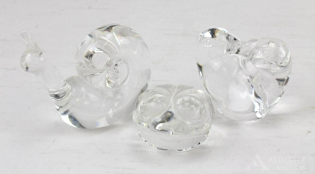 Steuben Paperweights: Grouping of (3) Steuben crystal paperweights including a snail, lovebirds hand cooler and frog hand cooler, all signed. Measurements of items: 3.5" length; 2.25" length & 2.25" length.