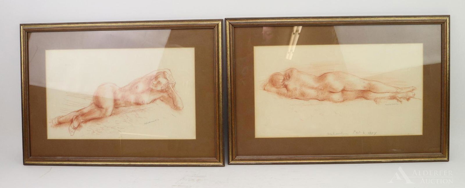 Reginald Marsh (1898-1954): Pair of framed red chalk sketches by Reginald Marsh (1898-1954). Reclining nudes, one pencil marked "Weehawken Pal-6 1384" and signed; the other signed and dated 1931. Measures 23" length x 16"h.