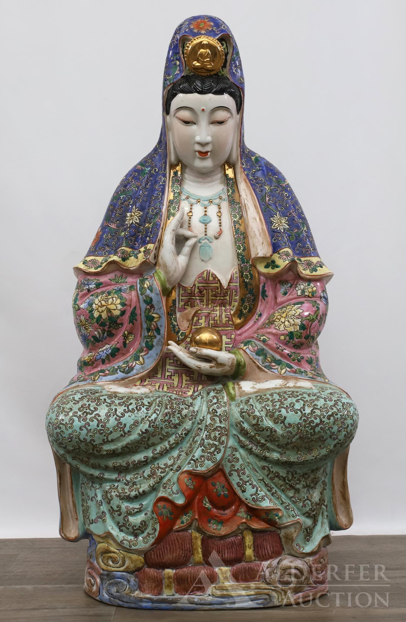 Chinese Porcelain Guanyin: Large Chinese enameled porcelain Guanyin seated atop a cloudy base in lotus position, holding a gilt pearl in her lap and her right hand in mudra. 32"h x 16"w x 9"d