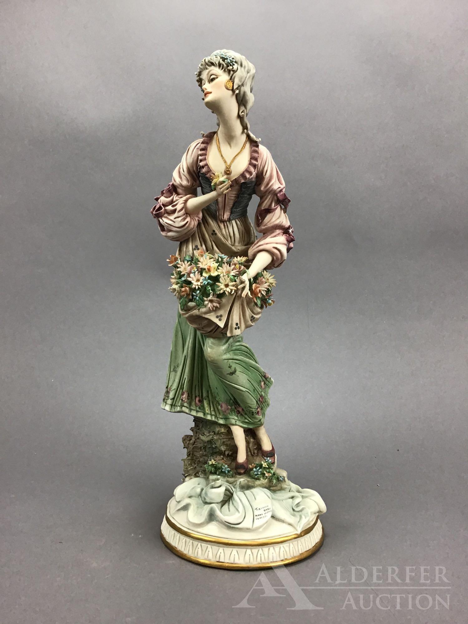 Capodimante Figurine: Italian porcelain figure of a woman with flowers, by Tiziano Galli, measuring 16.25”h.