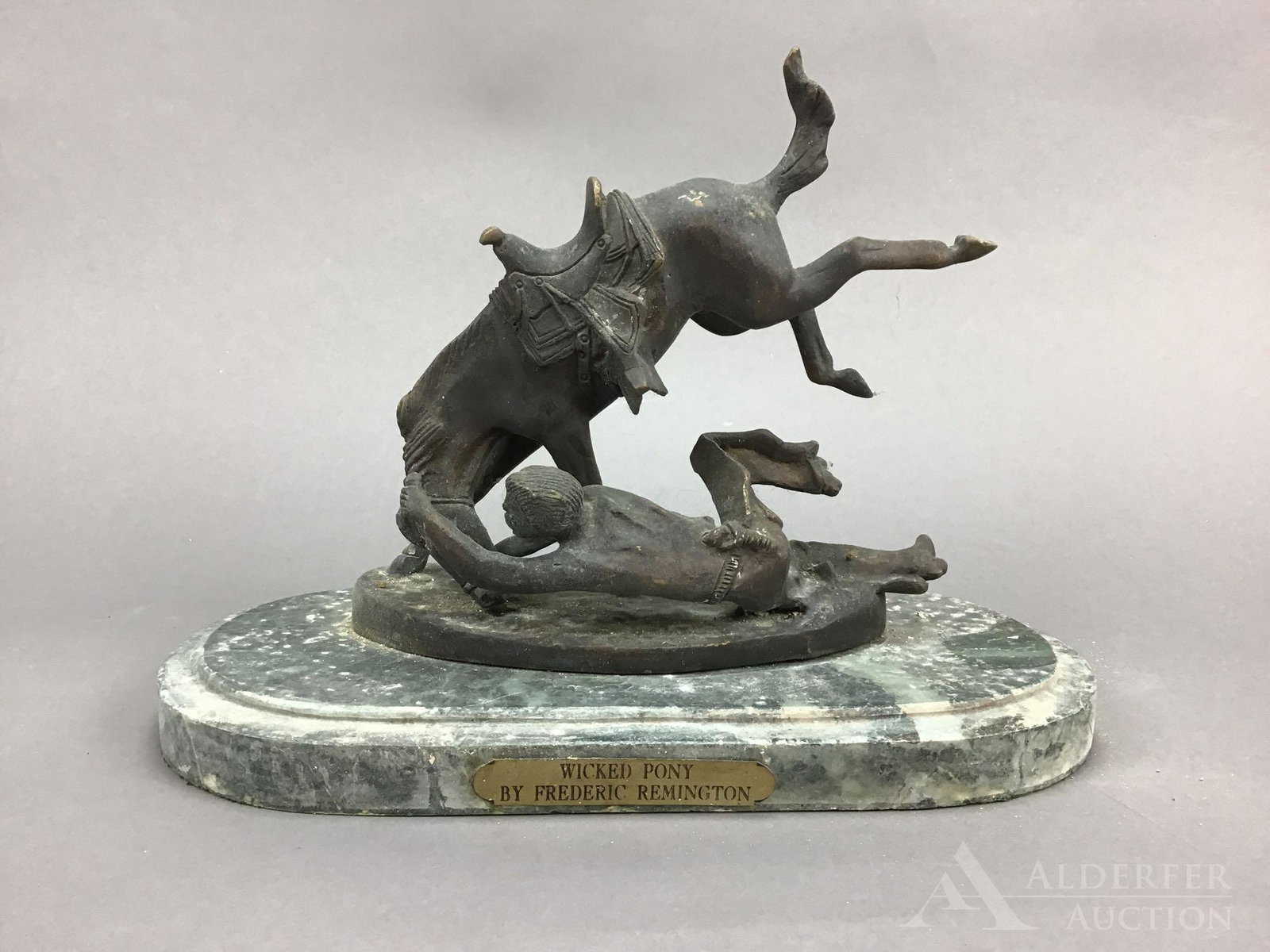 Frederic Remington Bronze: Bronze depiction of Remingtons "Wicked Pony", a figural depiction of a man trying to wrangle a horse. 9.5”h x 12.5”w x 6”d