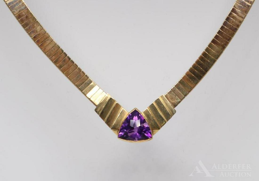 14KY Gold Amethyst Necklace: Flat omega style with fancy stepped "V" centerpiece features (1) 12mm checkerboard top trillion. 16" long. 36.1gtw.
