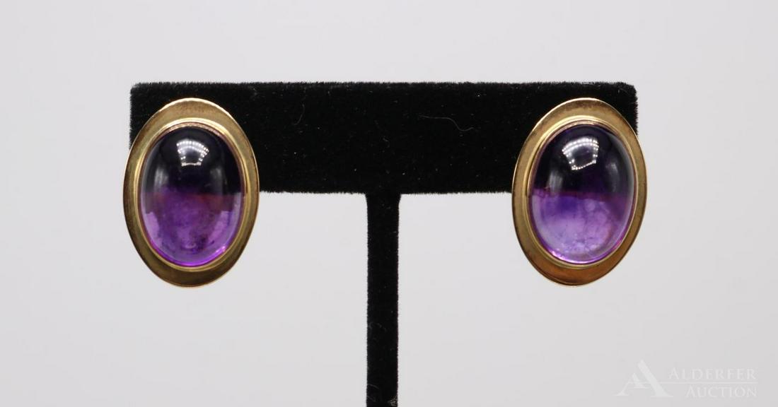 14KY Gold Amethyst Earrings: Each earring features (1) 18 x 13mm oval, 10mm deep Amethyst cabochon. Post with cushioned wire omega. Pair: 14.4gtw.