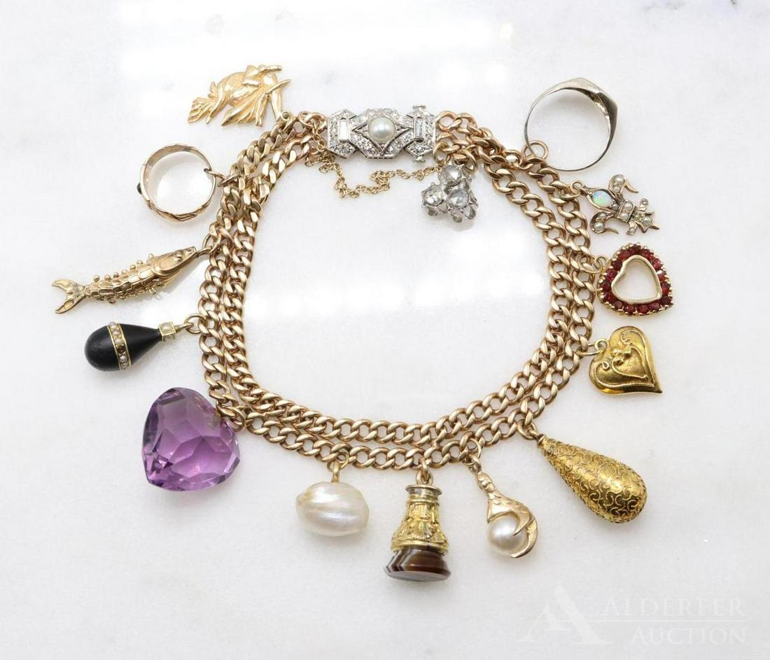 10KY Gold Charm Bracelet with Diamond Clasp: 10KY double curb chain with Diamond and Pearl Platinum and 18KW clasp and (14) assorted dangles including triple rose cut Diamond, signet ring, 10KY Opal and seed Pearl Fleur de Lis type, 14KY Heart 