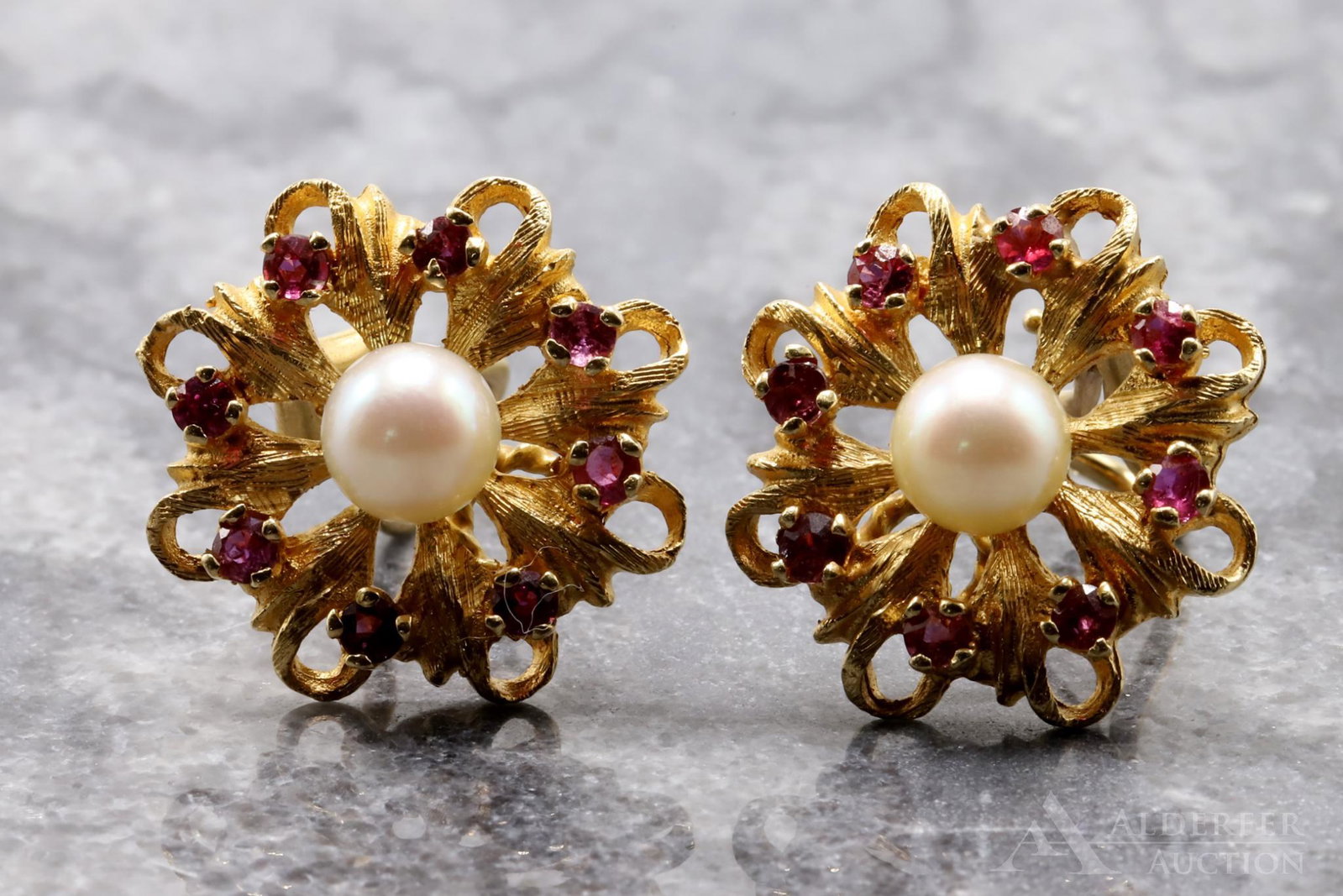 14KY Gold Ruby and Pearl Earrings: Each omega back non pierced earring features a floral setting with a central 6.6mm round Pearl encircled by (8) round Rubies. 3/4". Pair: 6.4dwt, 10.0gtw.
