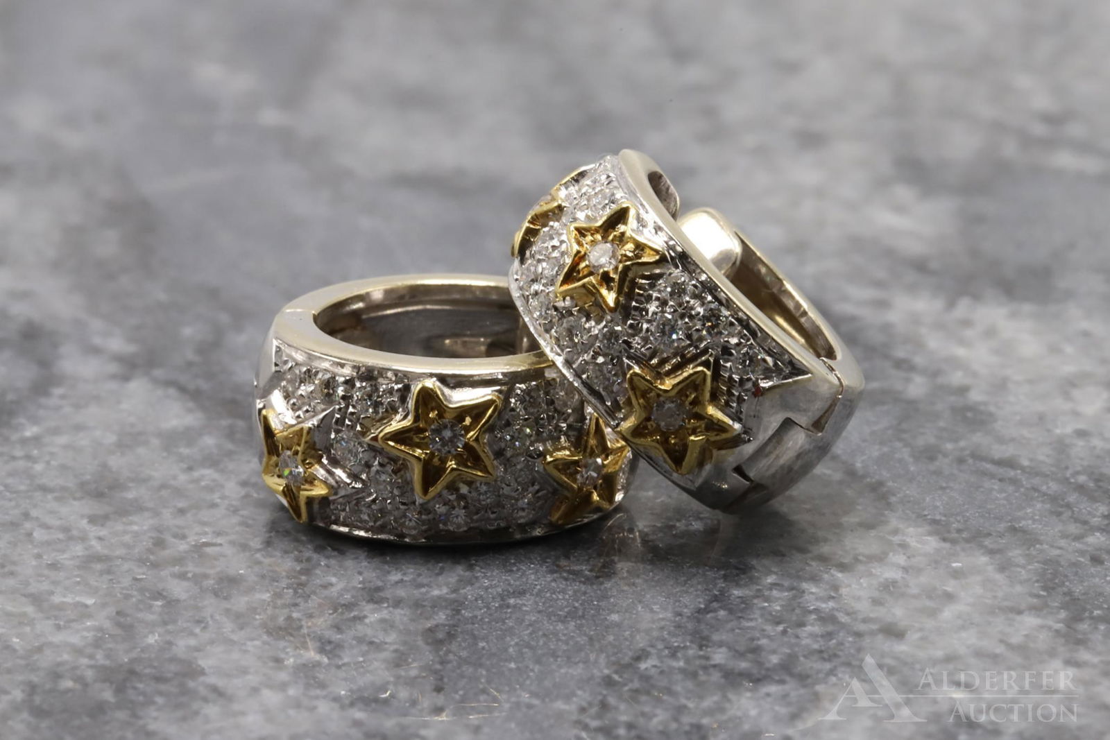 Chimento 18K Gold Diamond Huggie Earrings: Two-tone huggie hoop earrings with yellow gold stars and (20) small round Diamonds in each earring accenting the white gold settings. 15.8mm O.D., 7.7mm wide. 6.9 dwt, 10.7gtw.