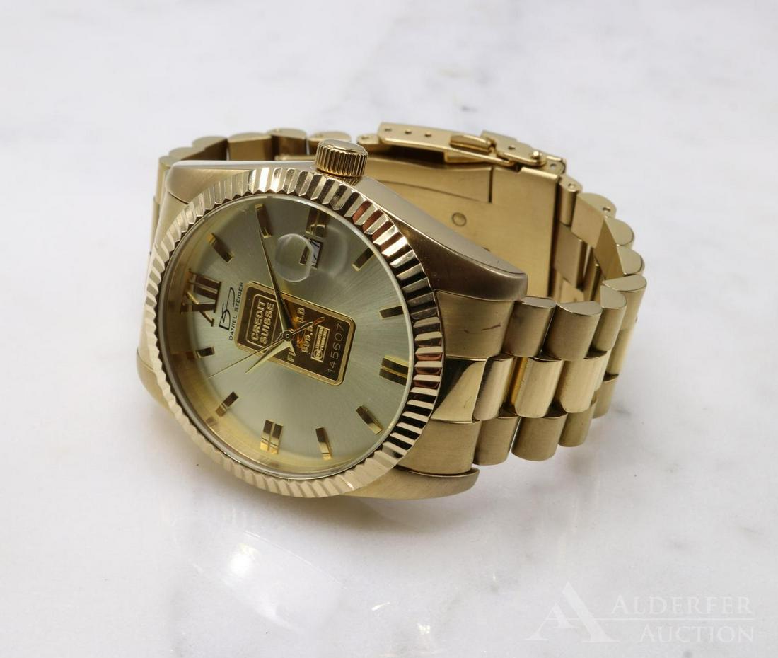 Daniel Steiger 999.9 Gold Ingot Wrist Watch: 18k gold plated watch with a Credit Suisse 1g 999.9 pure gold ingot set into the dial.