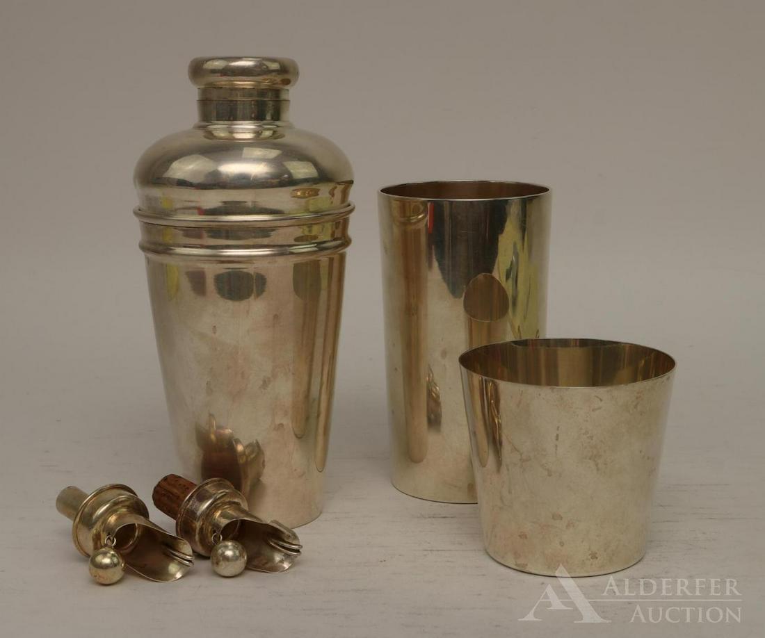 Tiffany & Co. Sterling Silver Barware: Includes a cocktail shaker, tumblers and pourers. Tumblers hallmarked Tiffany and Co. sterling, shaker is silver soldered electroplate. Largest is 8"h x 4"round. 22.5 ozt not including pourers and EP 