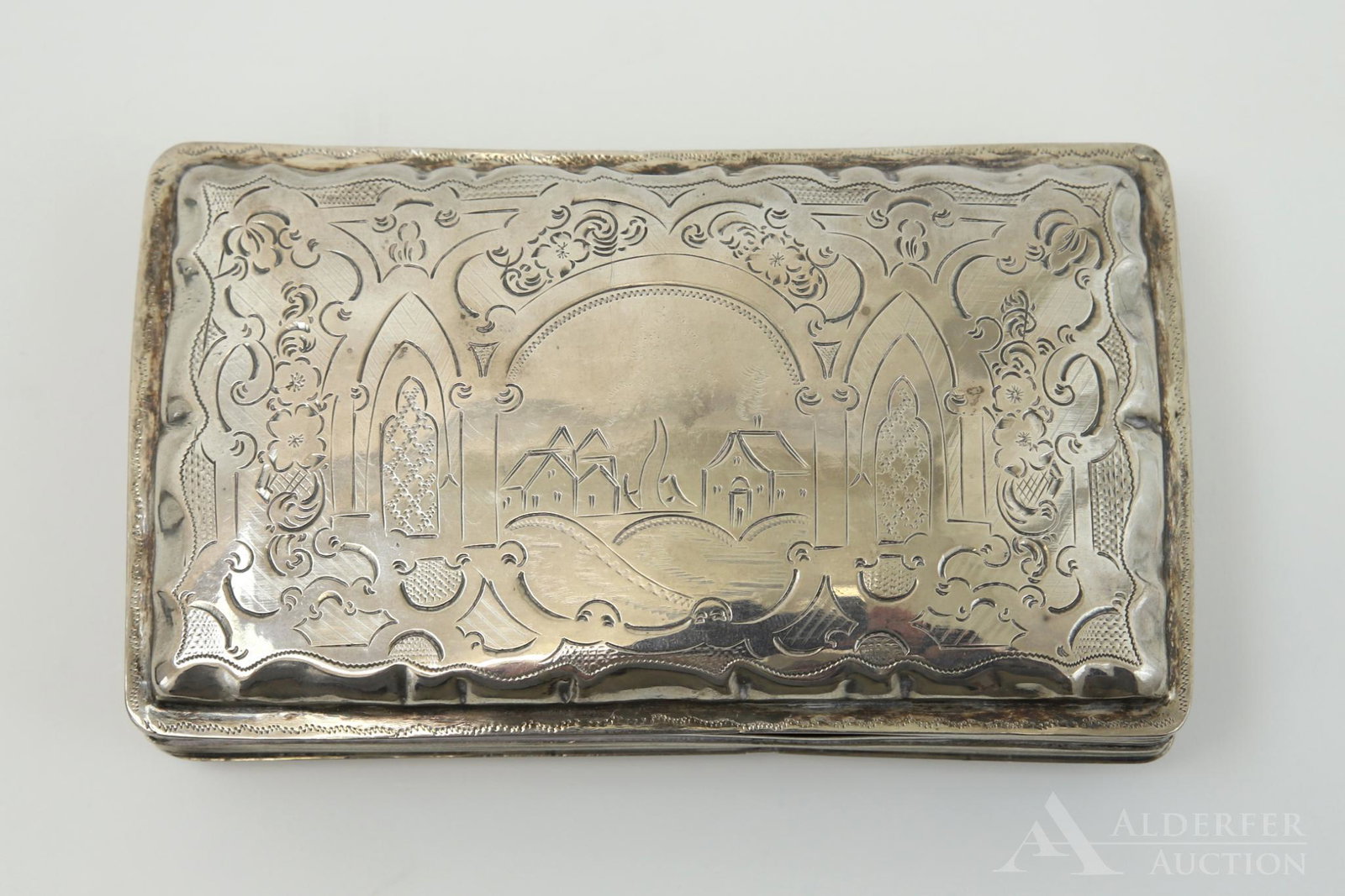 Antique Sterling Silver Box: Hand chased English box decorated with a village scene and other architectural elements. 1.5"h x 5.5"w x 3.25"d. 4.5 ozt