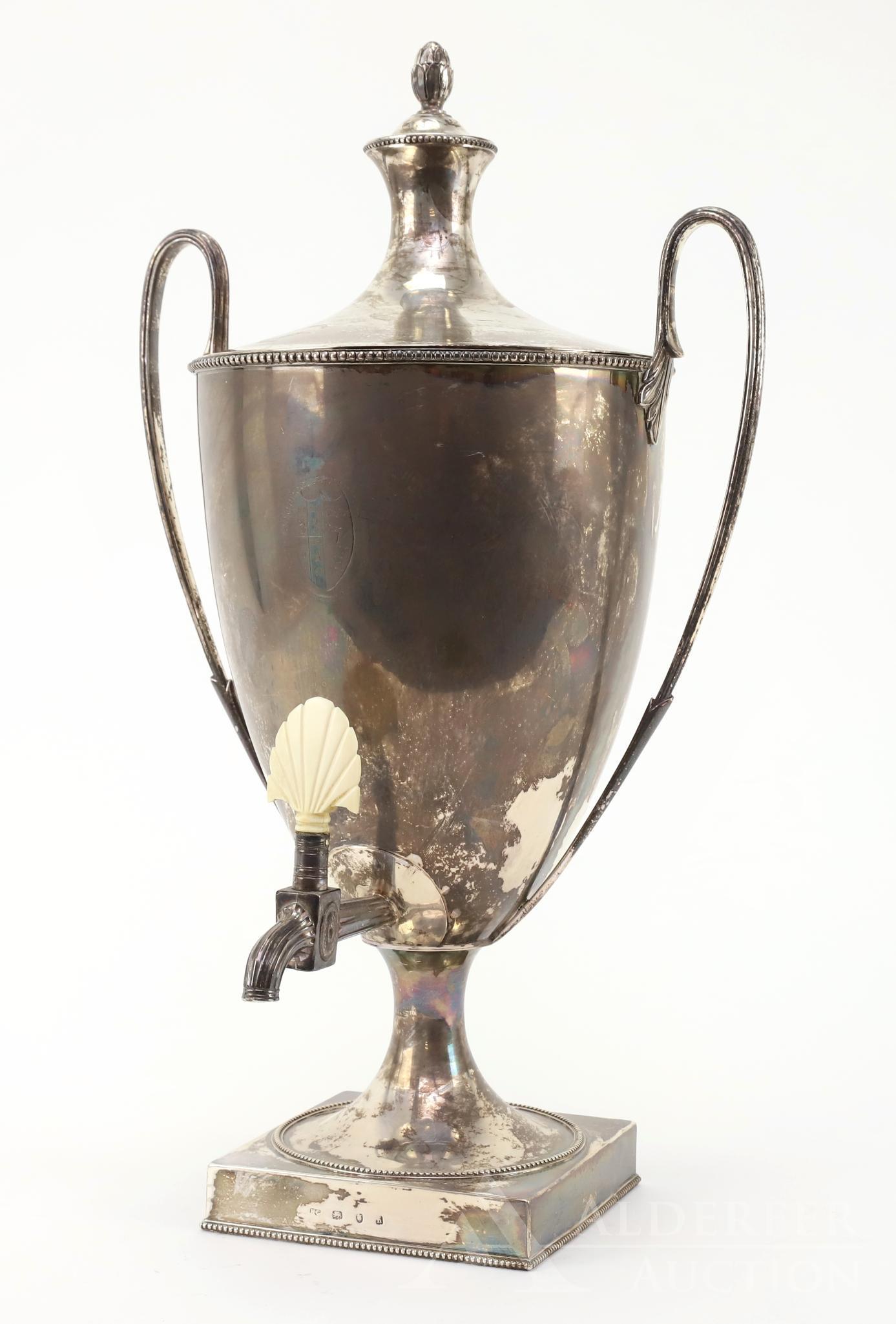 English Sterling Silver Tea Urn: English sterling silver tea urn, decorated with a coat of arms, a "fideliter" sigil of a hand holding a dagger and structurally decorated with beaded edges and cone finial. Unknown maker. 18.75"h x 