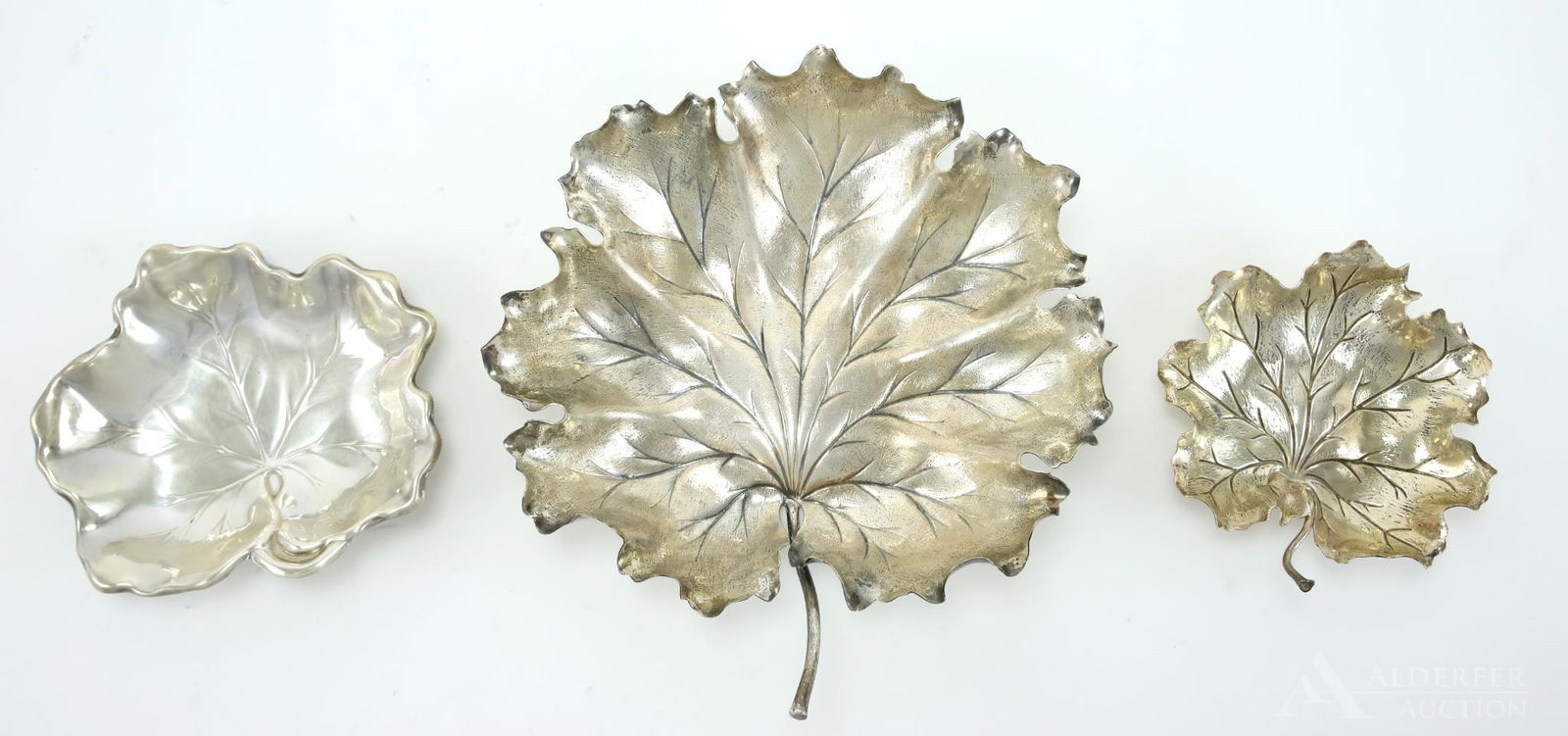 Buccellati Sterling Silver Leaf Form Dishes: Collection includes a pair of Italian Buccellati sterling silver finely detailed leaf dishes with a complementing Reed & Barton leaf dish. 8"h x 7.5"w, 4.5"h x 4.25"w and 4.75"h x 5.25"w, 12.5ozt