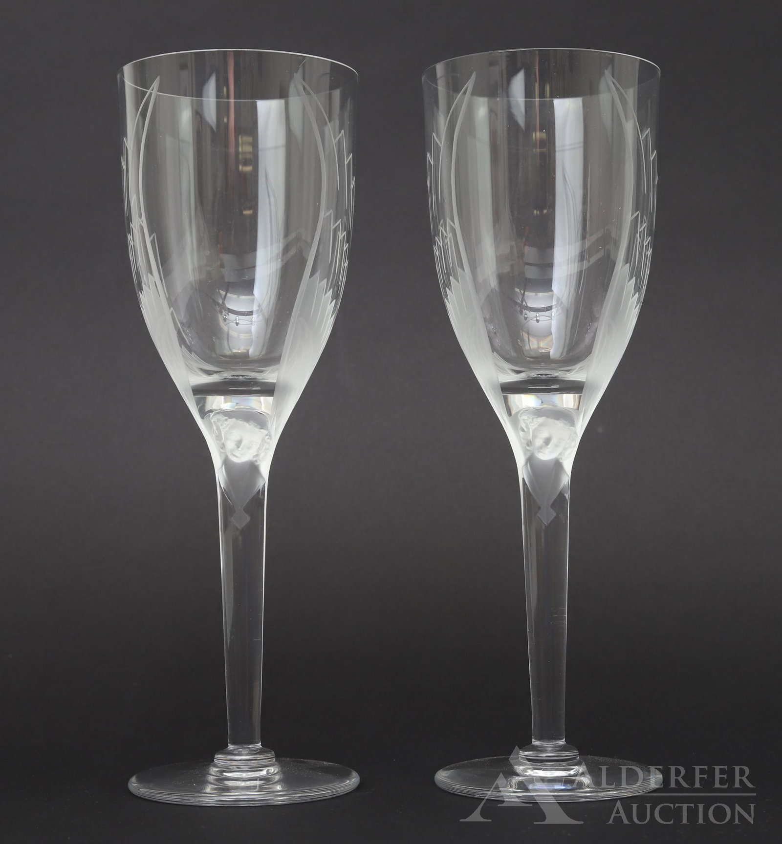 Lalique Crystal Stemware: Pair of signed lalique crystal stemware in the "Ange" pattern with frosted angels and etched wings. 8.25"h