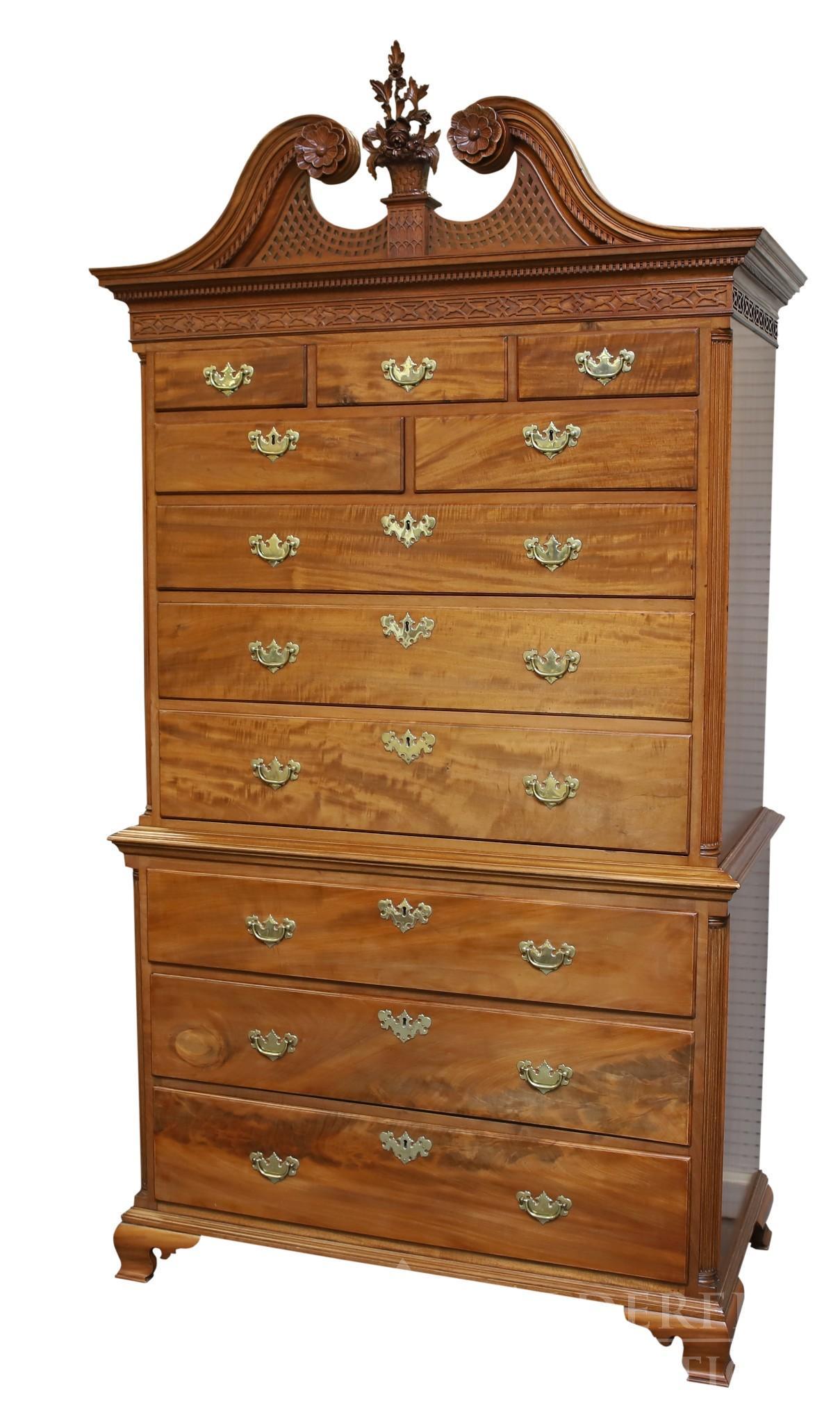 18th c. Mahogany Chest on Chest: Ornate broken arch rosette, floral basket, and fretwork pediment. Dentil molded cornice, Reeded quarter columns with three over two over six graduated drawers on ogee bracket feet. 90"h x 48"w x 25"d