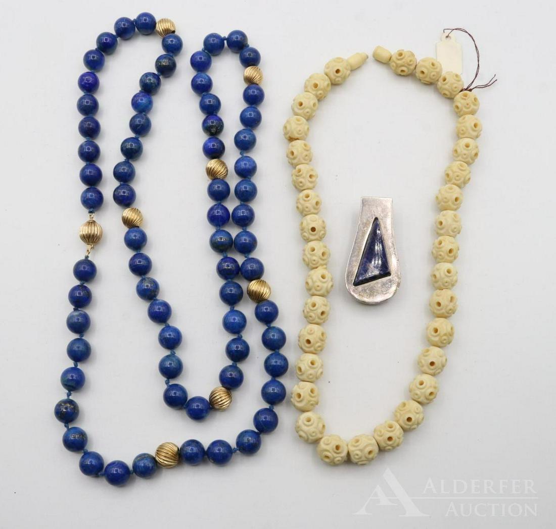 Lapis Jewelry: Grouping includes a 14k and lapis lazuli necklace (35"), a taxco sterling and lapis money clip, and a carved necklace (16")