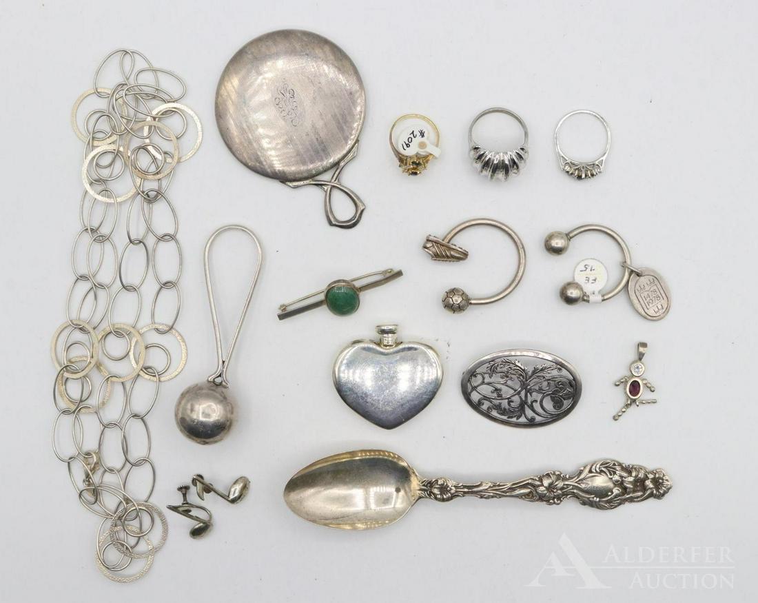 Sterling Silver Jewelry and Novelties, Tiffany & Co.: Grouping includes a Tiffany & Co. sterling silver heart shaped perfume bottle, a taxco sterling rattle, sterling necklace, sterling mirror, sterling spoon, a pair of keychains one with a tiffany charm