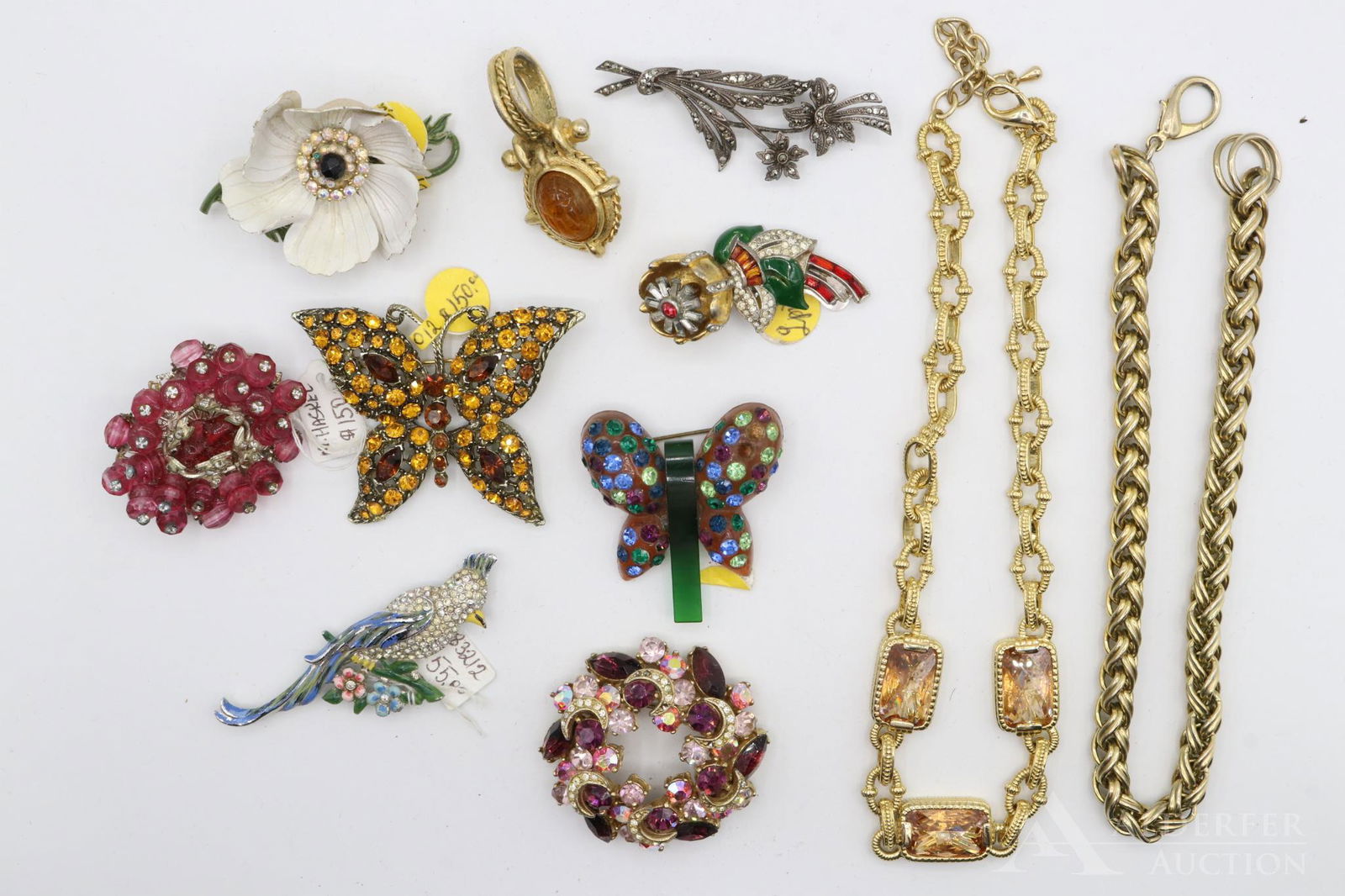 Costume Jewelry Brooches and Necklaces: Grouping includes examples by Lisner and Miriam Haskell including butterflies, birds and floral motifs. Largest brooch 2.75" and necklace 20"