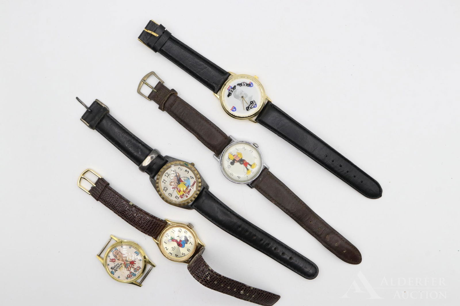 Vintage Wristwatches, Mickey Mouse: Grouping includes a Walt Disney productions Mickey Mouse watch, a Lorus Goofy, a Spiro Agnew watch, Roy Rogers and Dale Evans (cracked crystal) and an OJ Simpson watch. Largest 36mm