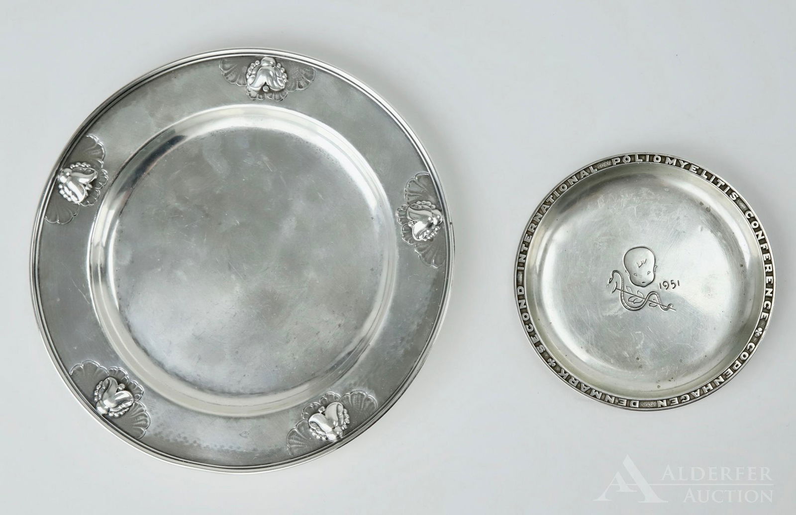 George Jensen Sterling Silver Tablewares: Grouping includes a wine coaster (428c), and a pin tray from the second international poliomyelitis conference in Denmark. Largest is 6"round, 5.37ozt