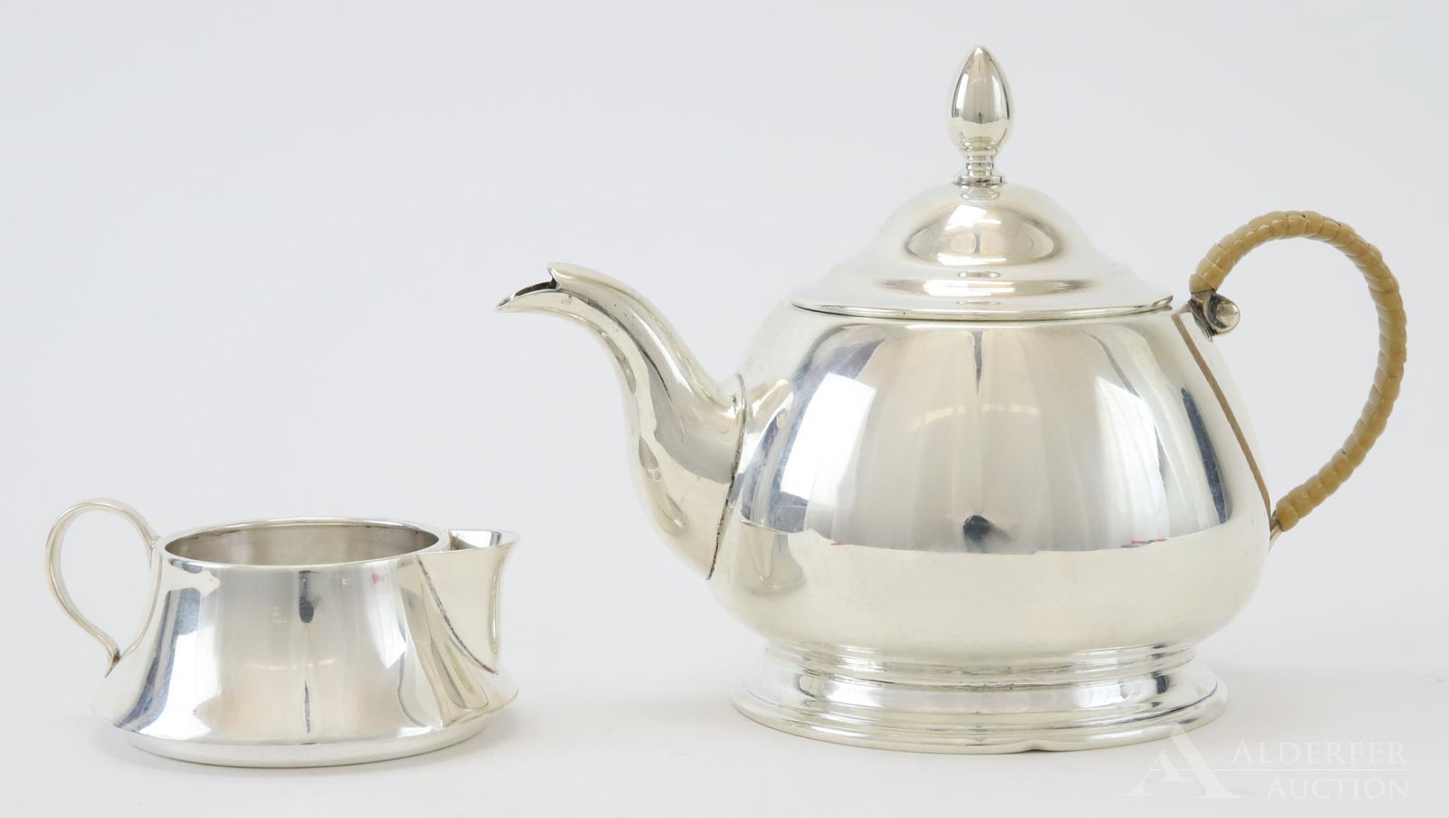 Cartier Sterling Silver Tea Service: Diminutive set by Cartier, teapot with wrapped handle, open sugar and wide based open creamer. The creamer acts as the cover for the sugar. All in the 1921 pattern. 11.81 ozt and largest 4.75"h x 6"w 