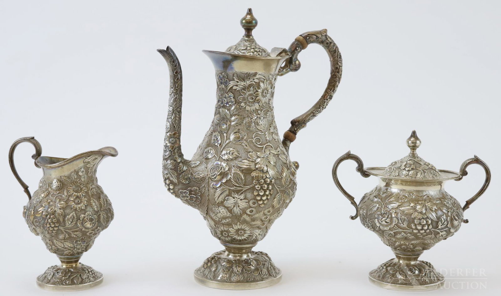 Sterling Silver Demitasse Service: Finely repousse'd service by Loring Andrews Co., decorated with grapes, strawberries and floral sprays. Includes hot water pot, covered sugar and creamer. 34 ozt and tallest 9.75"h x 7.5"w