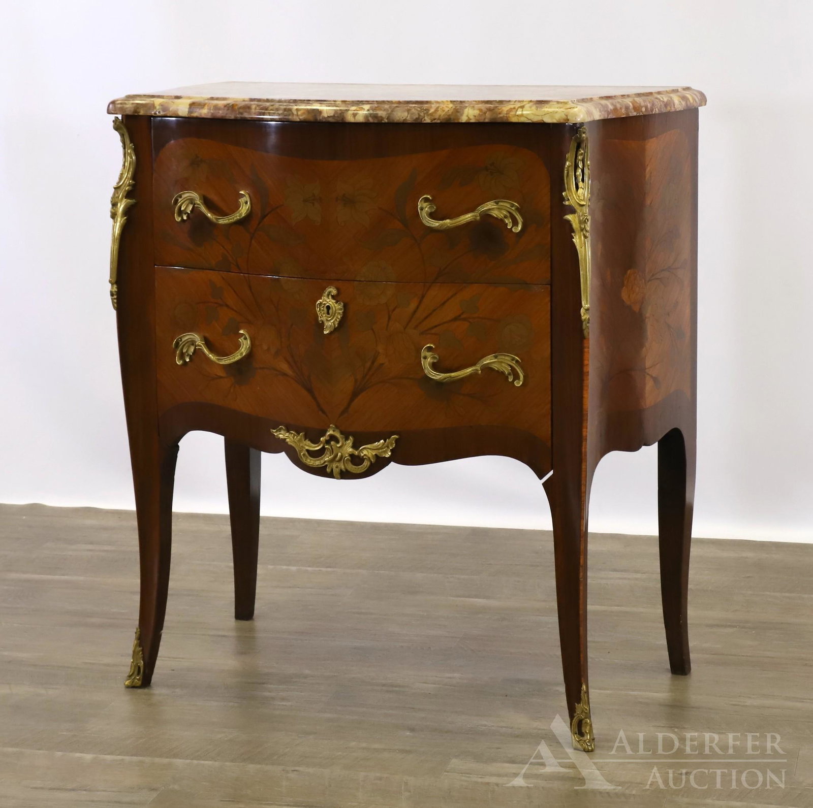 French Marquetry and Ormolu Mounted Commode: Serpentine marble top over two drawers with a scrolled apron on cabriole legs. 32"h x 30.5"w x 17"d