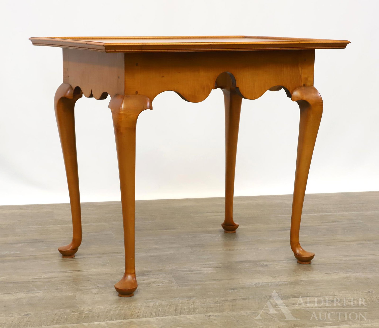 Tiger Maple Tea Table: In the Queen Anne style with a tray form, peg joinery top over a shaped skirt on cabriole legs and pad feet. Signed by Pennsylvania based restorer "Howard Szmolko" on underside. 27"h x 31"w x 21"d