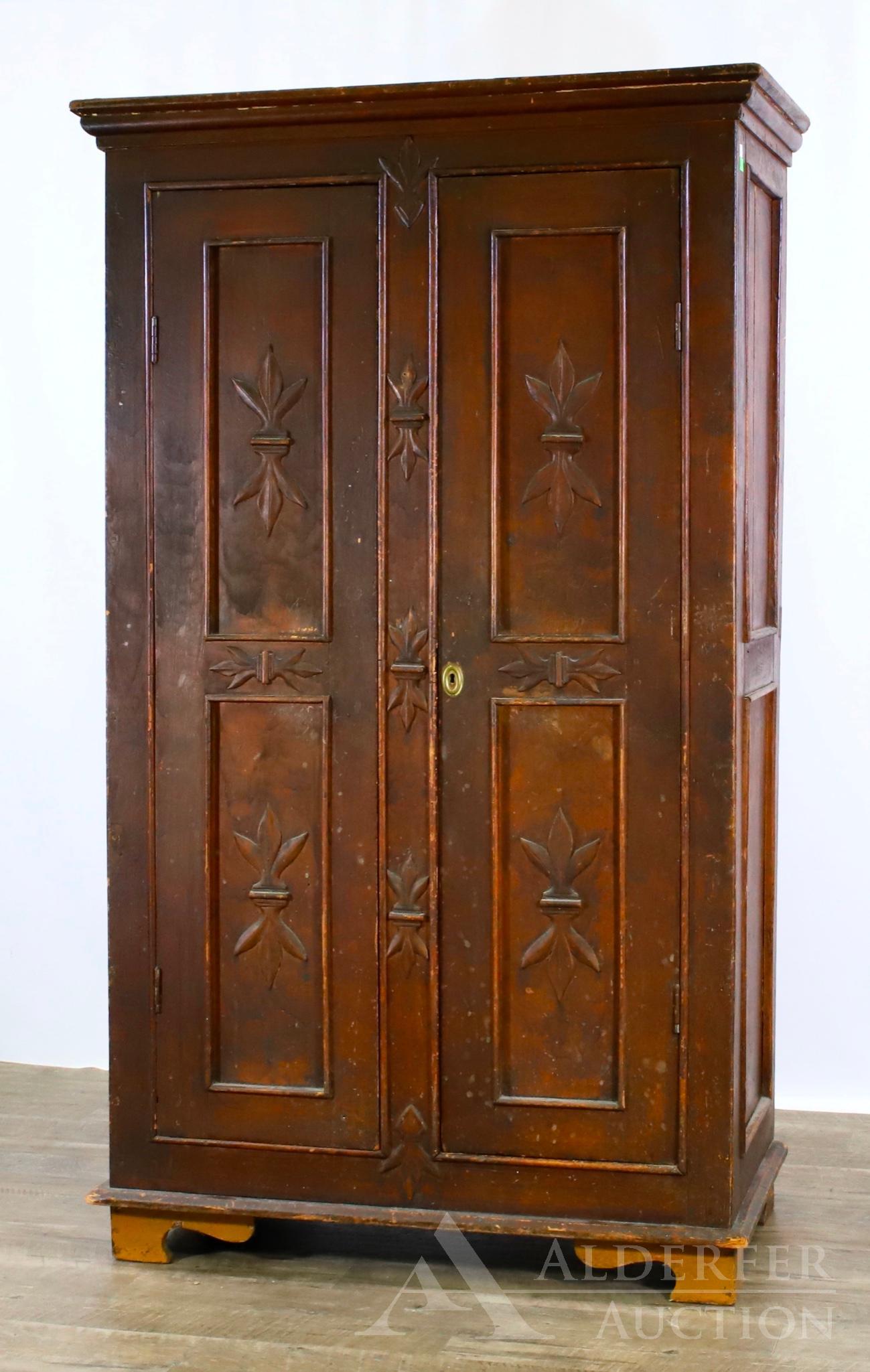 Pine Wall Cupboard: Molded cornice with relief inverted foliate motif paneled doors, paneled sides, on shaped feet. 65"h x 39"w x 19"d